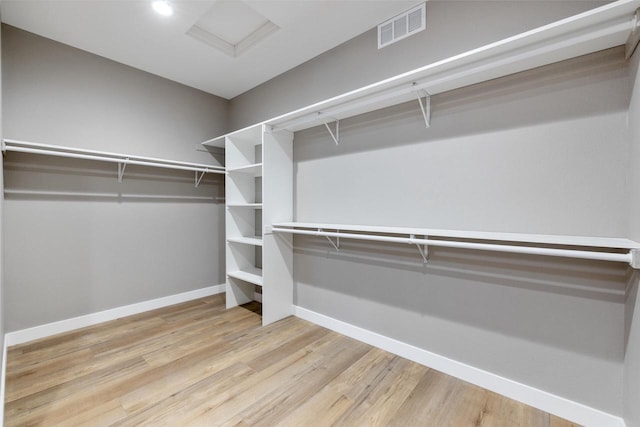 spacious closet with light hardwood / wood-style floors