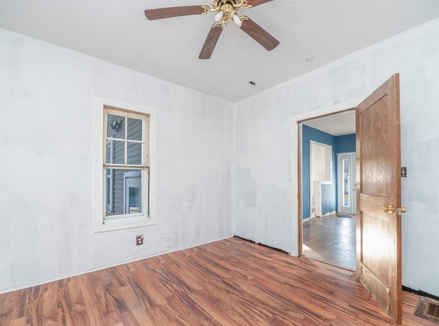 spare room with hardwood / wood-style floors and ceiling fan