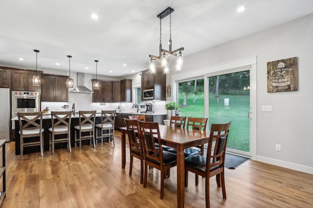 dining area featuring sink and light wood-type flooring