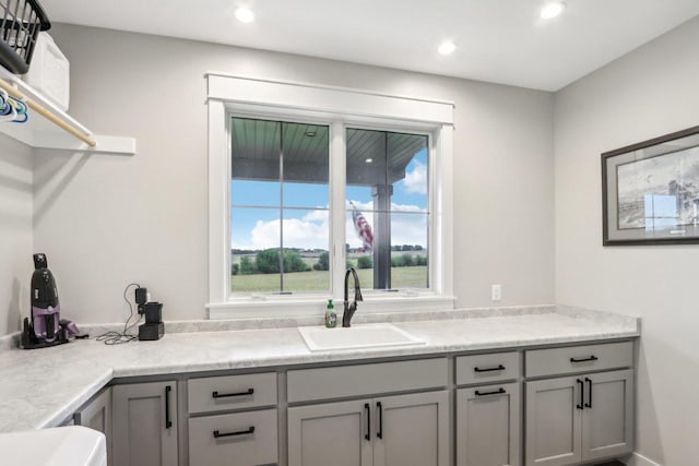 kitchen with gray cabinetry and sink