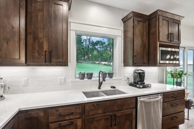 kitchen with sink, dark brown cabinets, and stainless steel appliances