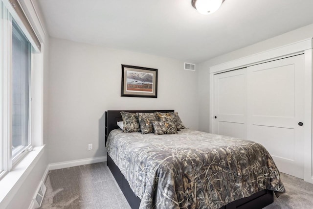 bedroom with carpet flooring and a closet