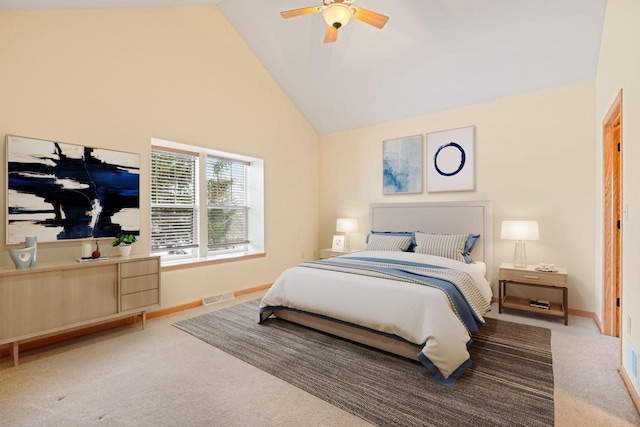 carpeted bedroom with high vaulted ceiling and ceiling fan