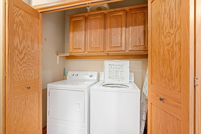 washroom with cabinets and independent washer and dryer