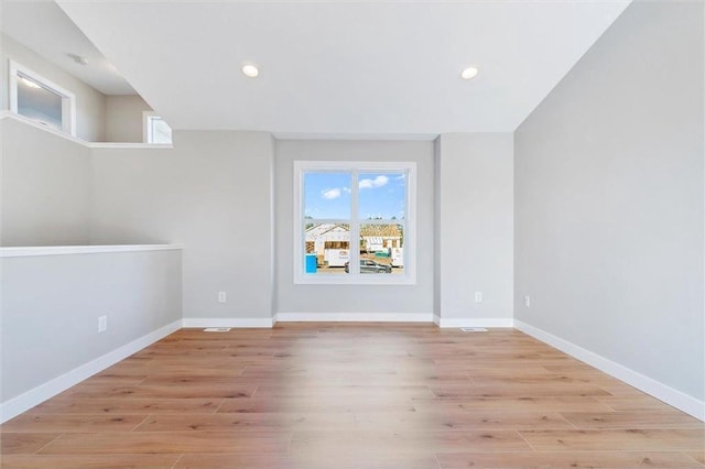 unfurnished room featuring light hardwood / wood-style flooring and a healthy amount of sunlight