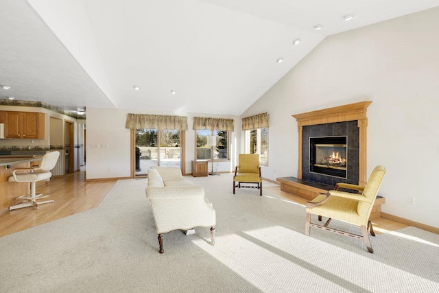 living room with light colored carpet, a fireplace, and vaulted ceiling