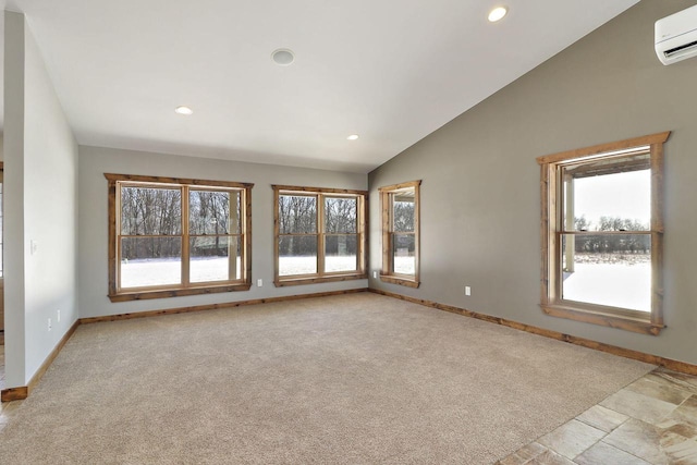 spare room featuring lofted ceiling, a wall mounted air conditioner, and light carpet