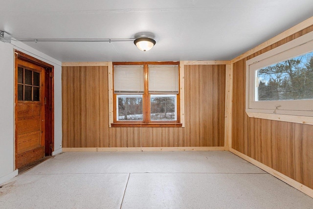 spare room featuring wood walls