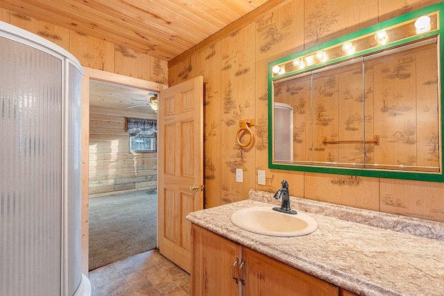 bathroom featuring wooden ceiling, a shower with shower door, vanity, and wood walls