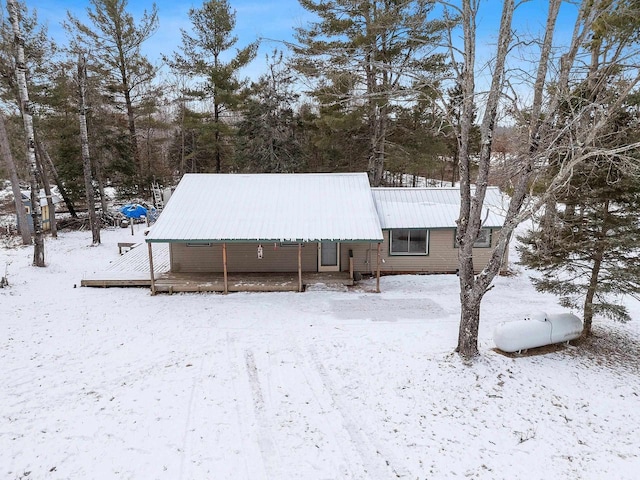 view of snow covered back of property