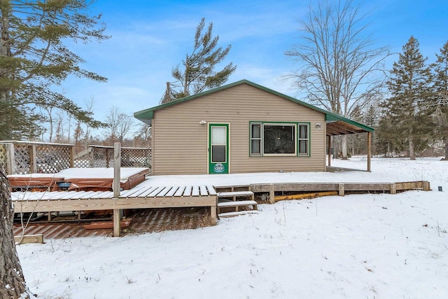 view of snow covered rear of property