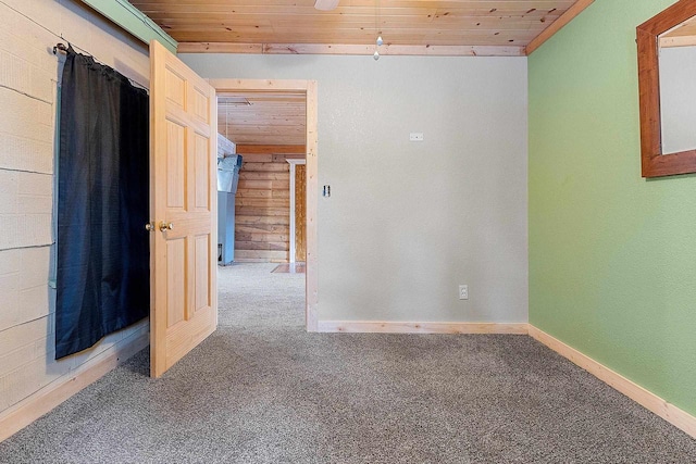 unfurnished room featuring carpet flooring and wooden ceiling