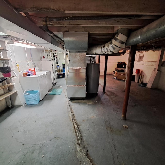 basement with gas water heater, heating unit, and washer and clothes dryer