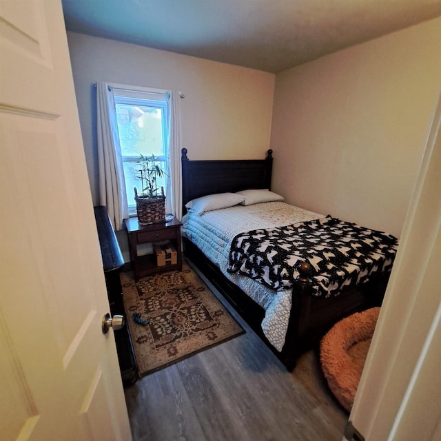 bedroom with dark hardwood / wood-style floors