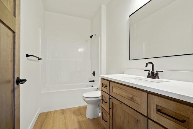 full bathroom with washtub / shower combination, vanity, toilet, and hardwood / wood-style floors