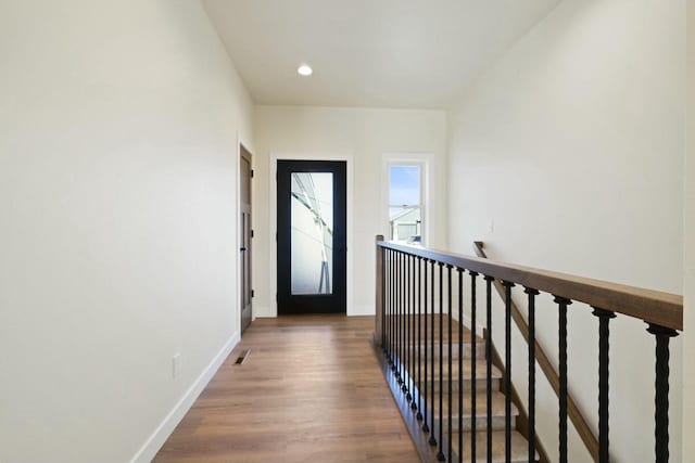 hall with wood-type flooring