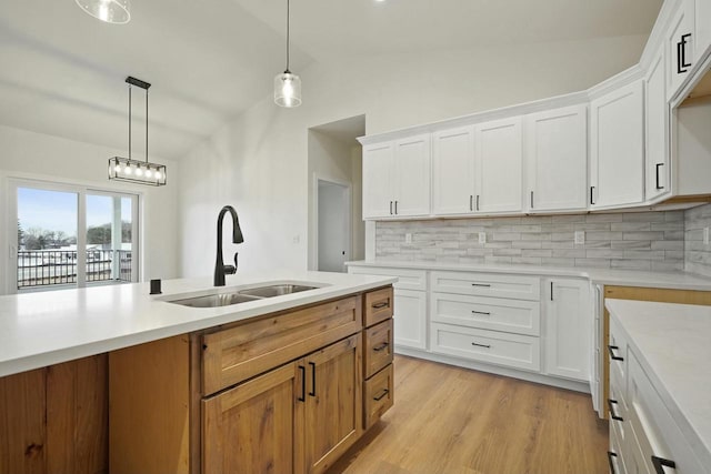 kitchen with tasteful backsplash, sink, and white cabinets