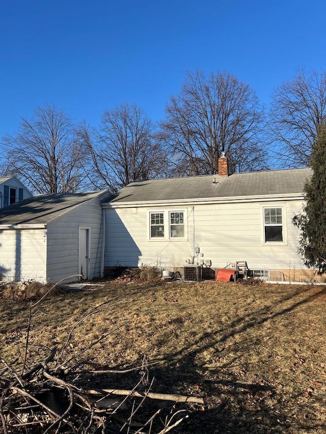 back of property featuring central air condition unit