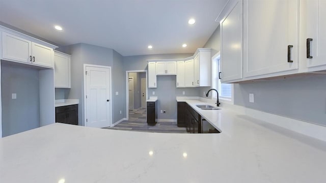 kitchen with sink, dark wood-type flooring, and white cabinets