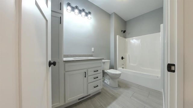 full bathroom featuring vanity, shower / washtub combination, and toilet