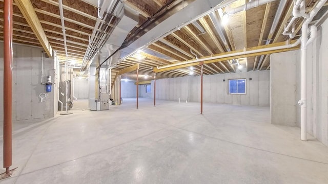 basement with water heater and heating unit