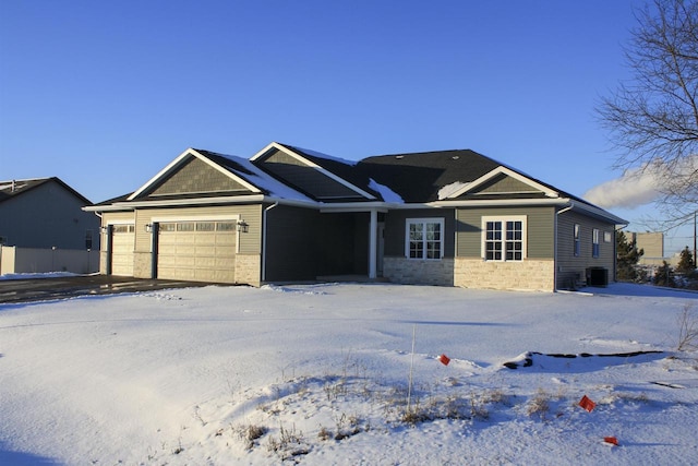 ranch-style home featuring a garage and central AC unit