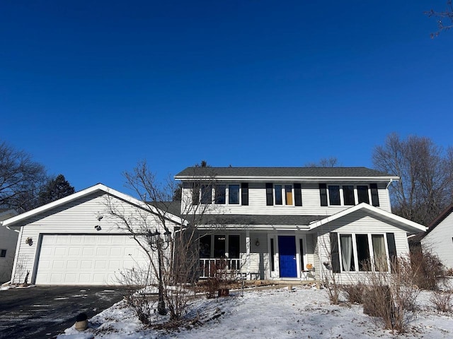 view of front of home featuring a porch and a garage