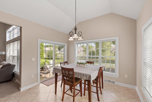 dining space with light tile patterned floors, a notable chandelier, and vaulted ceiling