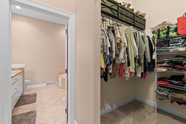 walk in closet featuring light tile patterned floors