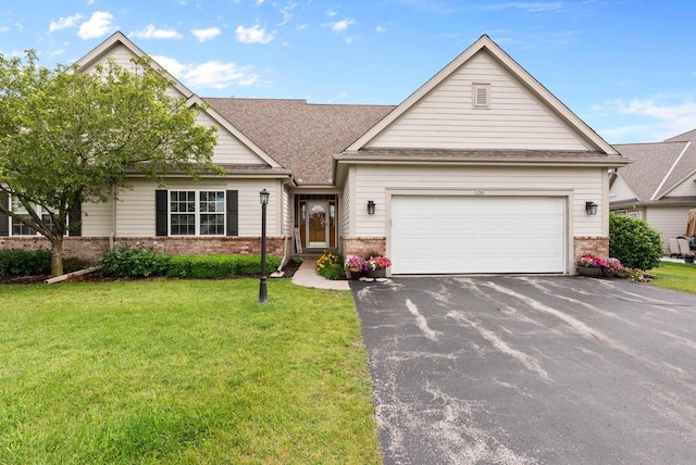 view of front of property with a garage and a front lawn