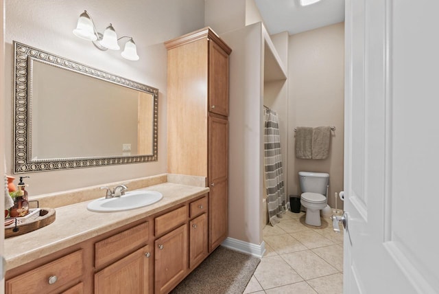 bathroom featuring vanity, tile patterned floors, and toilet