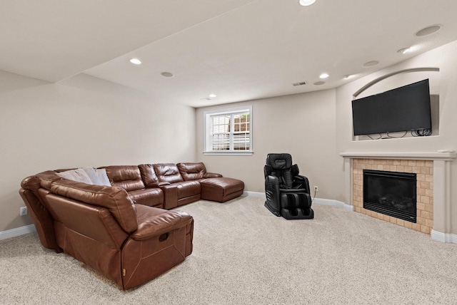 living room featuring a tile fireplace and carpet