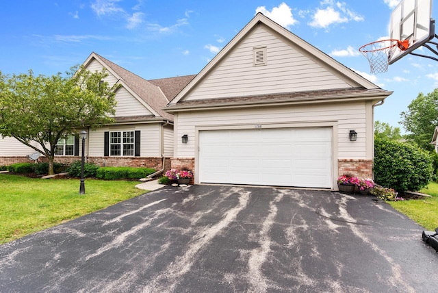 view of front of house featuring a garage and a front lawn