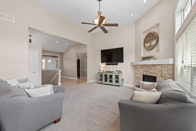 carpeted living room featuring ceiling fan and a fireplace