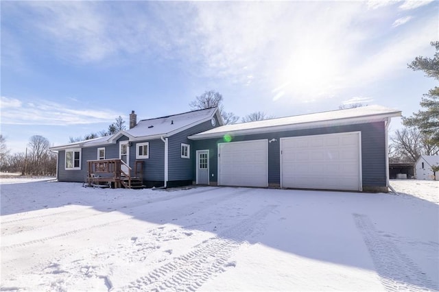 view of front of house with a garage and a deck