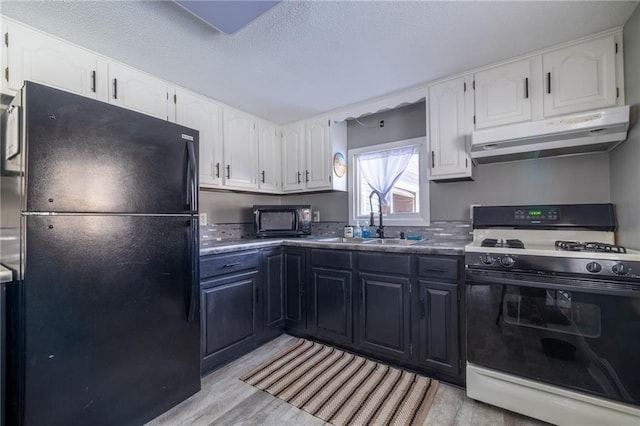 kitchen with white cabinetry, sink, and black appliances