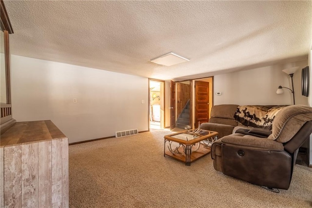 living room featuring carpet flooring and a textured ceiling