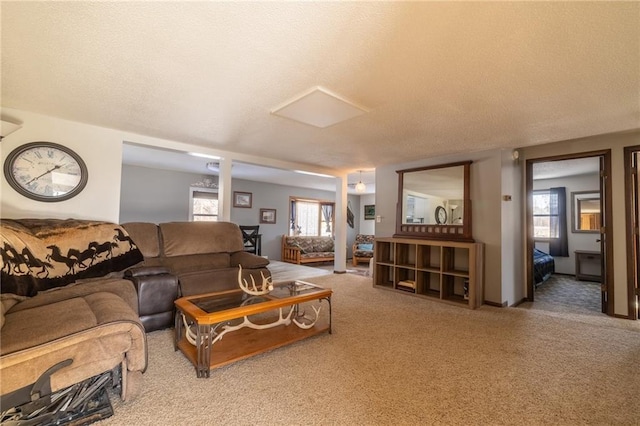 carpeted living room with a textured ceiling