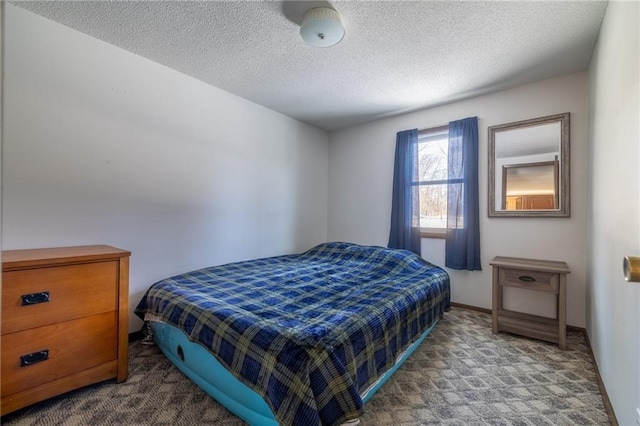 bedroom with carpet flooring and a textured ceiling