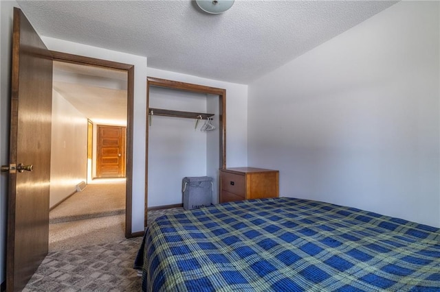 unfurnished bedroom with a closet, a textured ceiling, and carpet