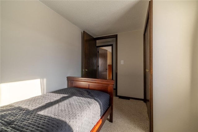 carpeted bedroom with a textured ceiling