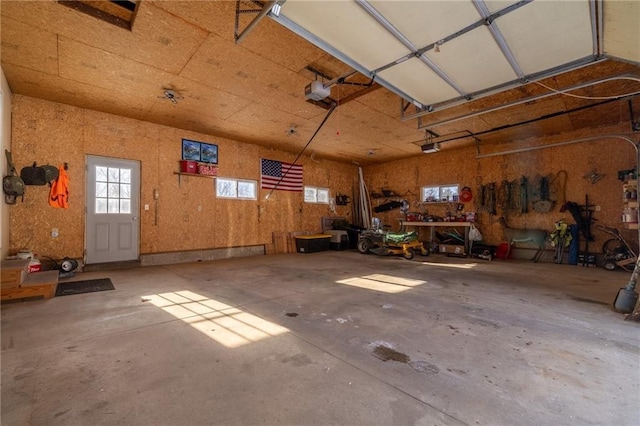 garage featuring a garage door opener and a workshop area