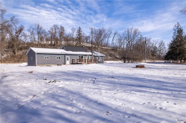 view of snow covered rear of property