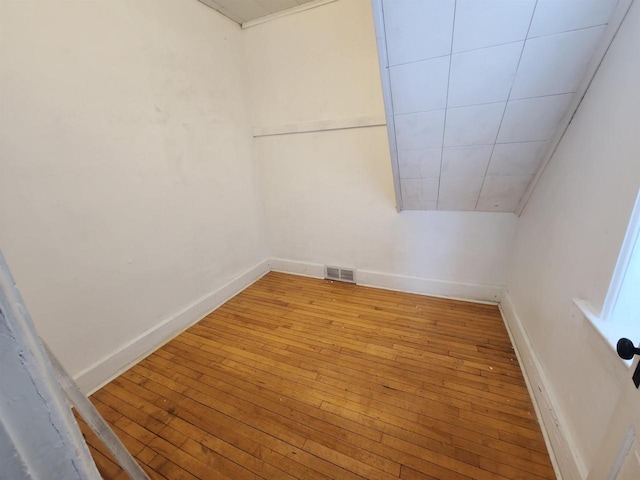 empty room featuring lofted ceiling and light hardwood / wood-style floors