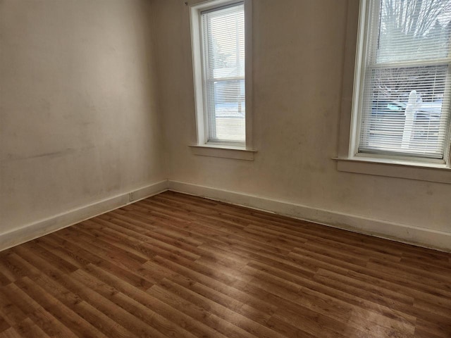 empty room featuring dark hardwood / wood-style flooring