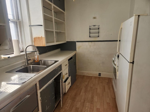 kitchen featuring dark hardwood / wood-style floors, dishwasher, sink, tile walls, and white refrigerator