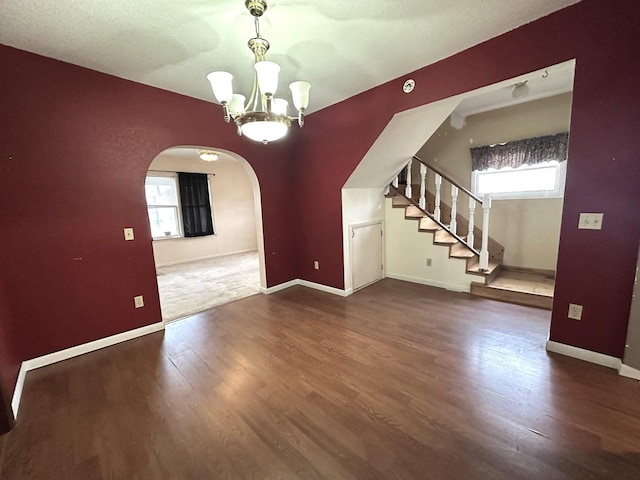 interior space with dark hardwood / wood-style floors and a notable chandelier