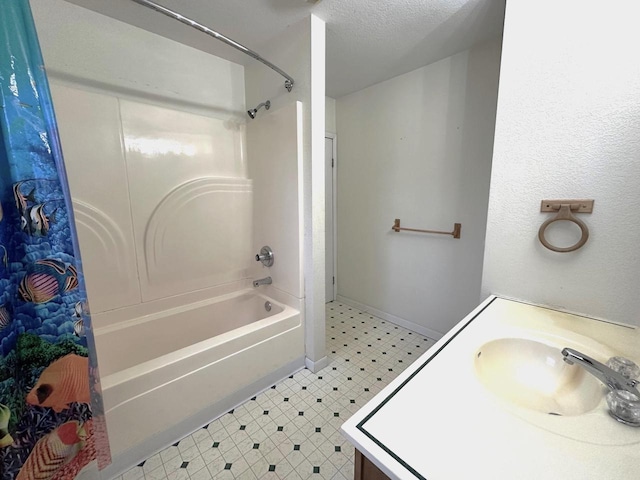 bathroom featuring vanity, shower / bath combination, and a textured ceiling