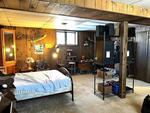 bedroom with wooden walls and carpet