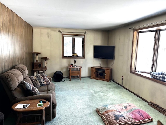 living room featuring light carpet and wood walls